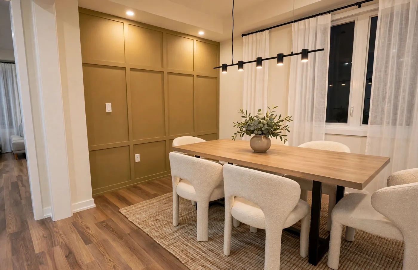 Dining room with an olive board-and-batten feature wall, pot lights and a linear pendant over the table